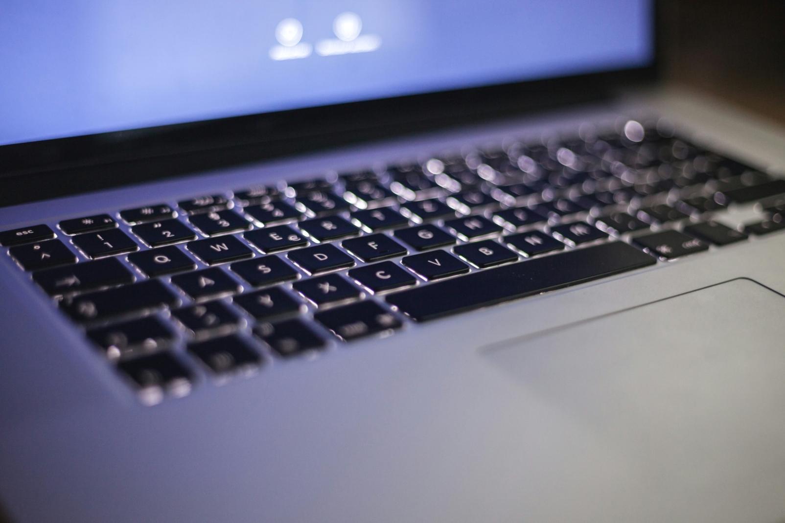 Researcher reviewing cybersecurity legislation documents at a workstation